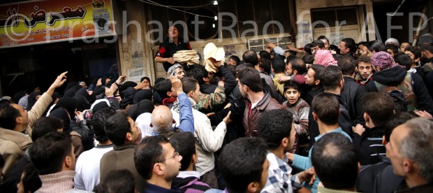 A bakery hands out bread in Aleppo, where residents are suffering from major shortages of bread. (© Prashant Rao for AFP)